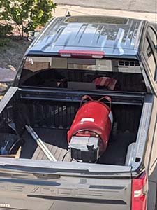 Donated Compressor in the back of a black pickup truck