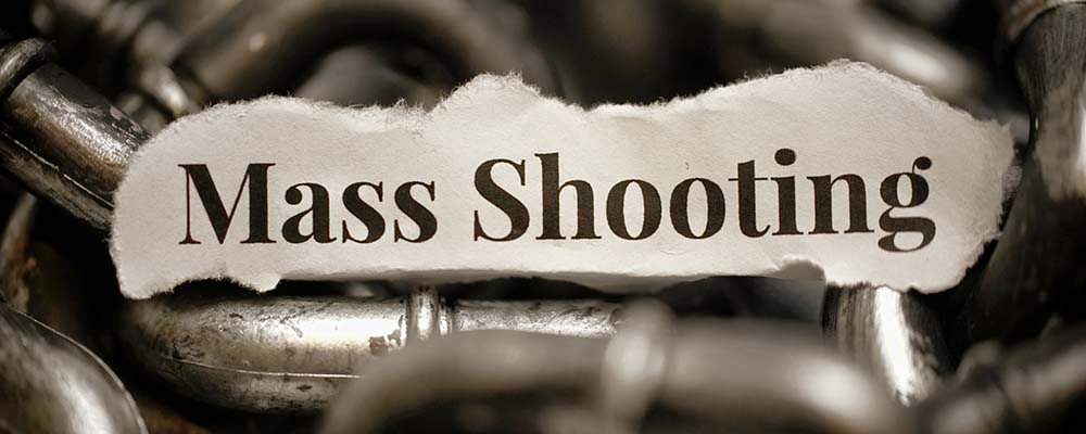 words mass shooting written on top of spent shell casings.