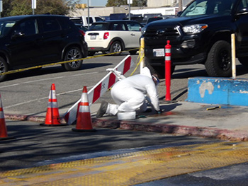 biohazard technician cleaning biohazards from a street