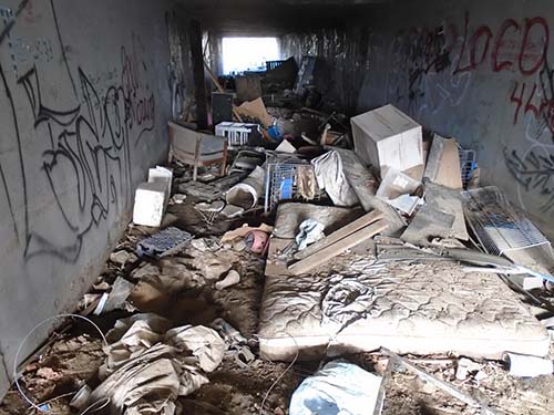 tunnel full of debris from a homeless encampment