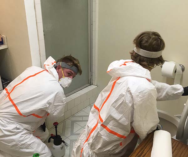 biohazard technicians working in a bathroom