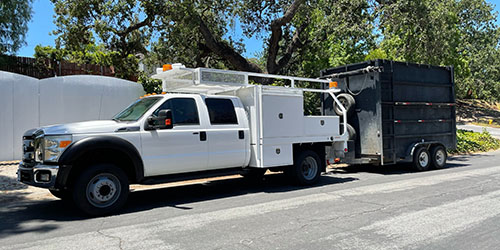 Bio SoCal's white unmarked truck and dump trailer