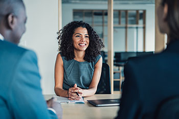 social worker smiling and talking with two other people