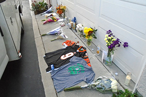flowers placed along a garage after suicide
