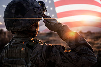 soldier saluting the U.S. flag
