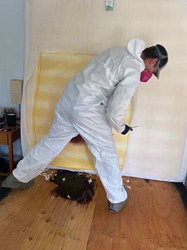 biohazard technician deconstruction a mattress after a death