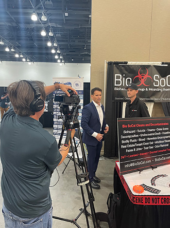 duke-at-aggla-2-350 camera man filming an interview with Bio SoCal at a booth at the AAGLA Expo